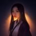 夜澄编辑头像，亚裔女性，专业照片风格，橙色暖光背景，表情自信，成人文学创作分析专家